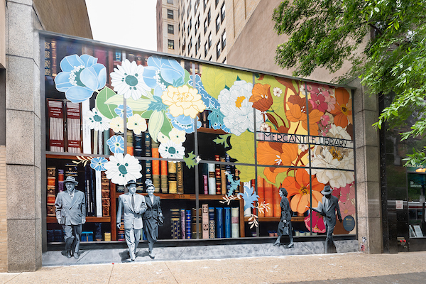 Glass storefront painted with colorful flowers.